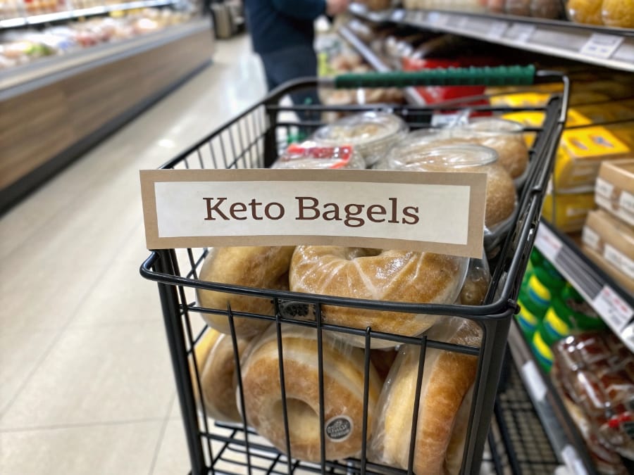 Packaged keto bagels sitting in a grocery cart in the bread aisle