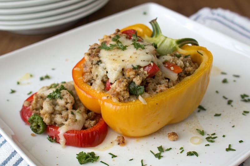 Low-carb high protein stuffed pepper cut in half on a plate