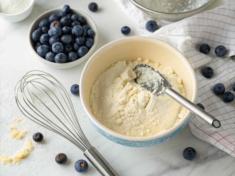 Mixing almond flour and protein powder for high protein blueberry muffins