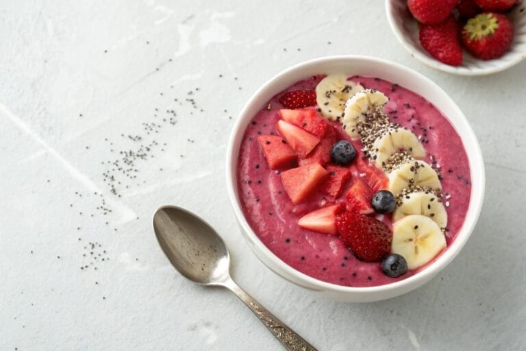 Simple dragon fruit smoothie bowl on light background
